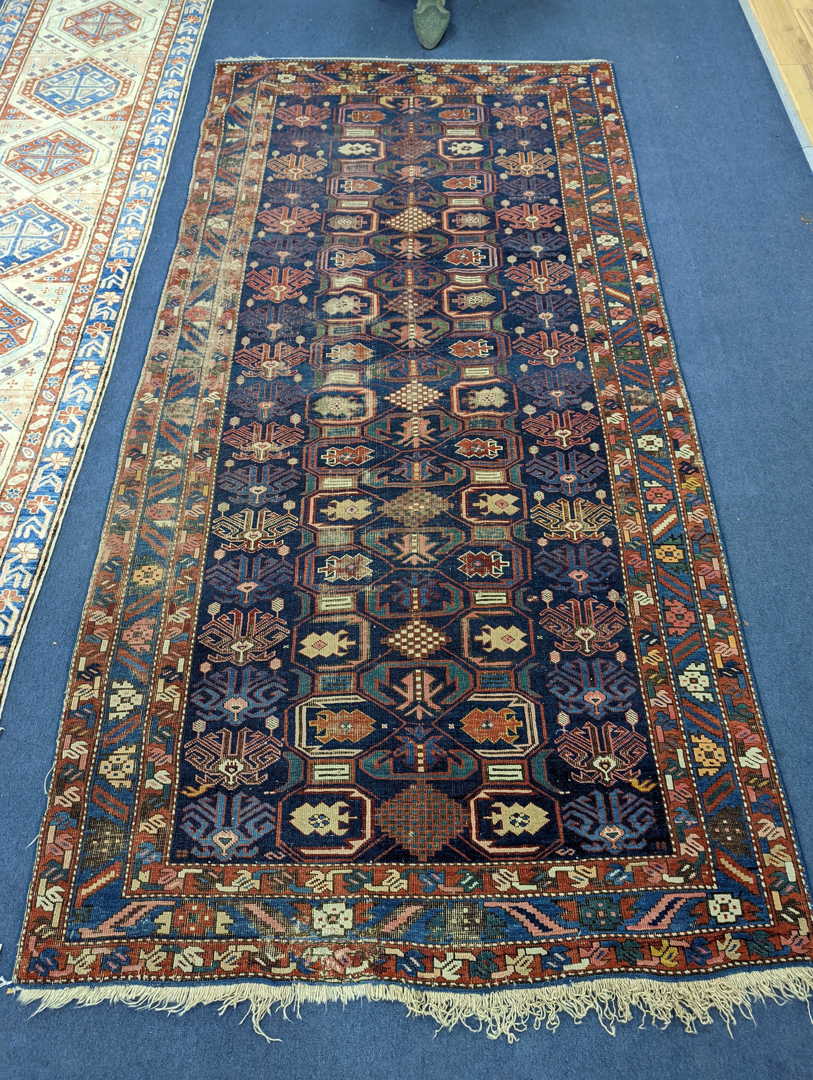 An antique Caucasian blue ground rug, 260 x 130cm